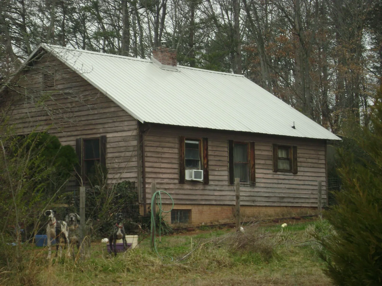 White metal roof on an old wood sided farmhouse, from a Metal Roof Installation job in Crossville